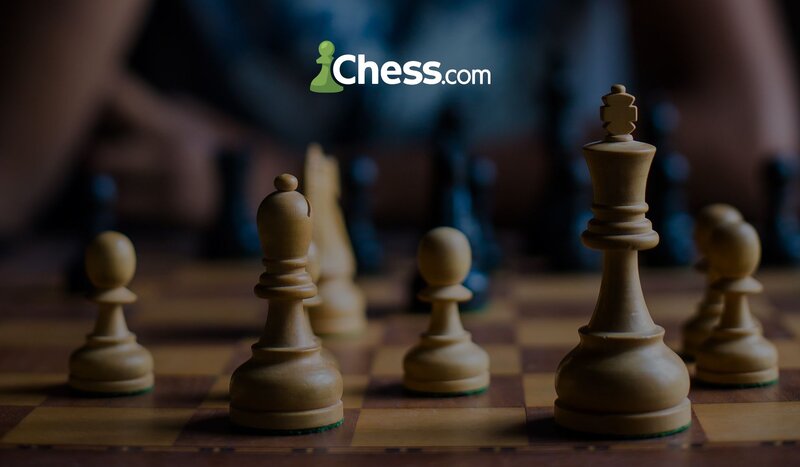 Elegant, white chess pieces with the Chess.com logo on top.