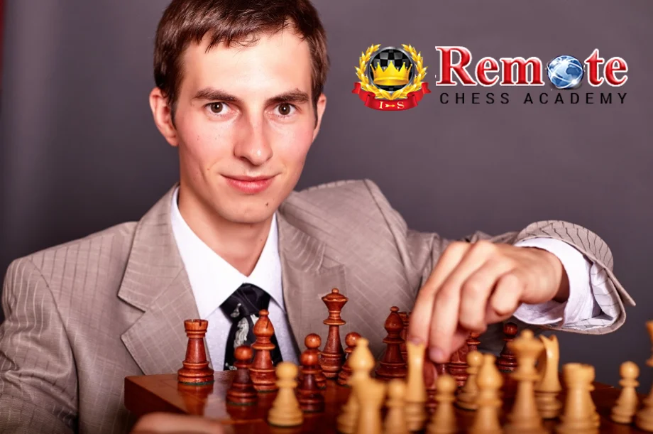 GM Igor Smirnov posing with chess pieces - Remote Chess Academy