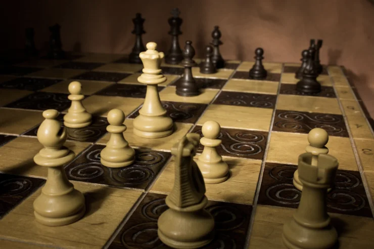 An elegant chess set with white pieces in the foreground and black pieces in the background.