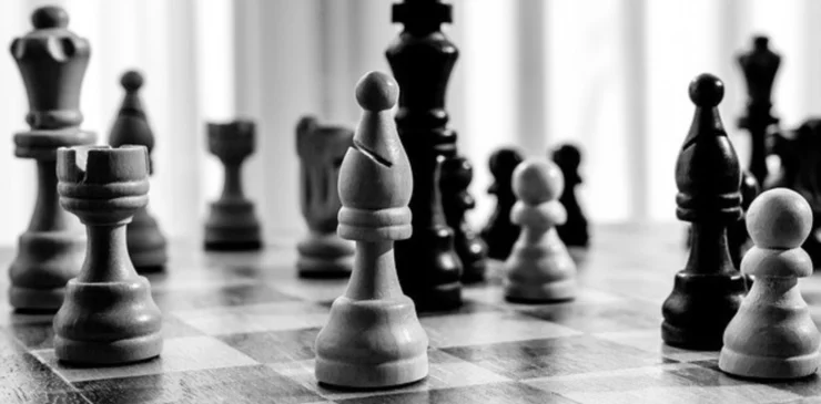 Black-and-white image of chess pieces on a chess board.
