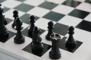 Black pieces in their starting position on a chessboard.