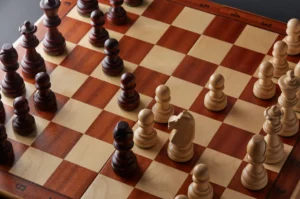 Top view of an elegant chess board, with a game underway in its opening phase.